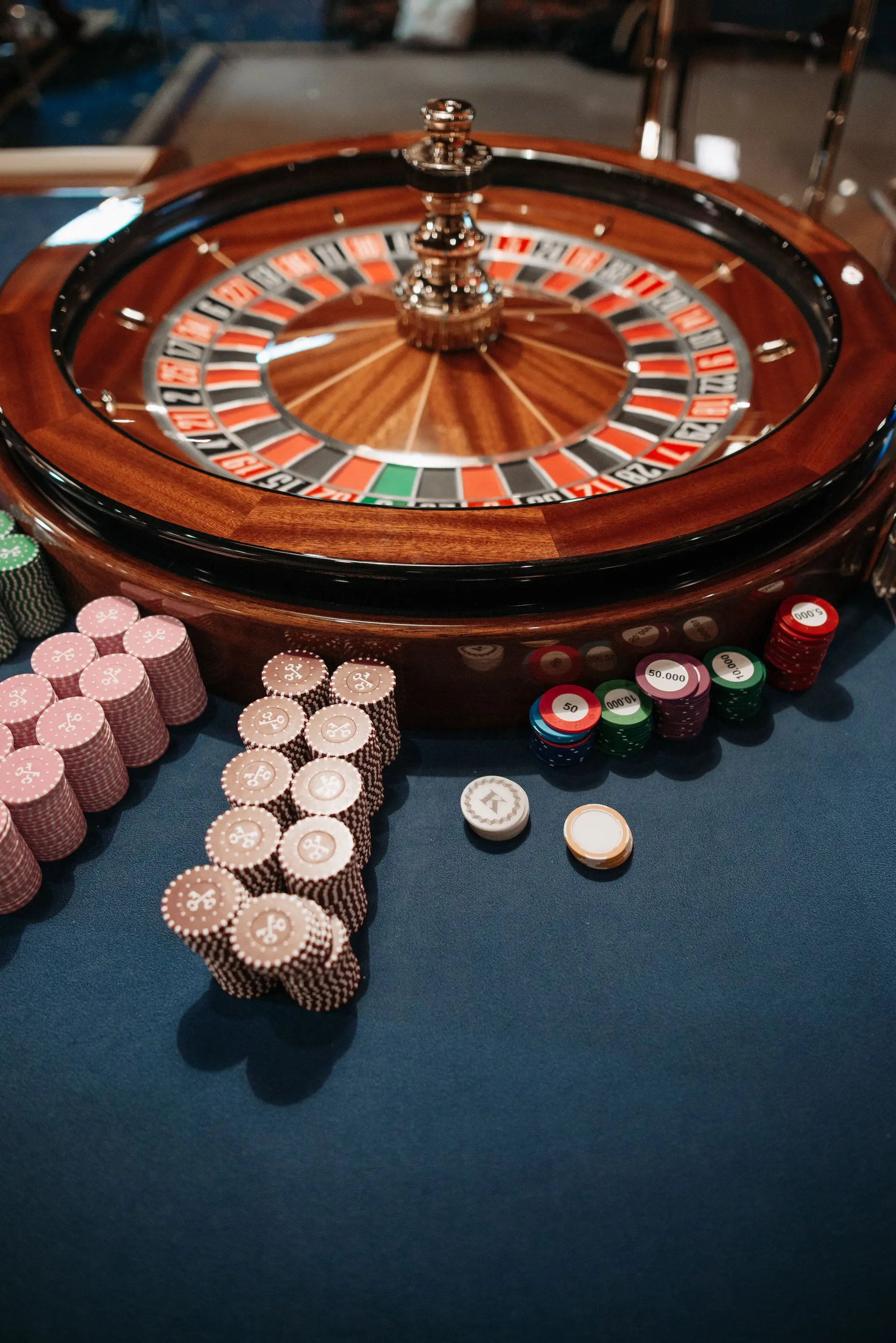 Close-up of roulette wheel and stacked chips