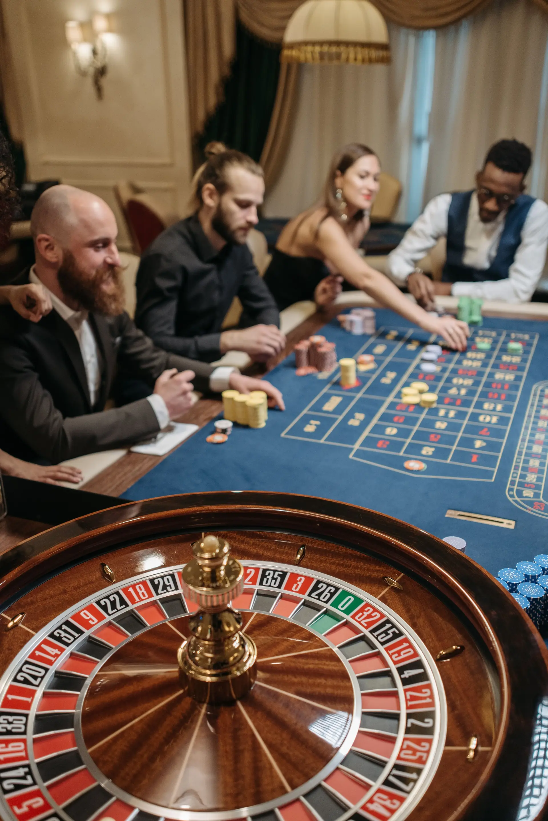 Sophisticated guests enjoying a game of roulette